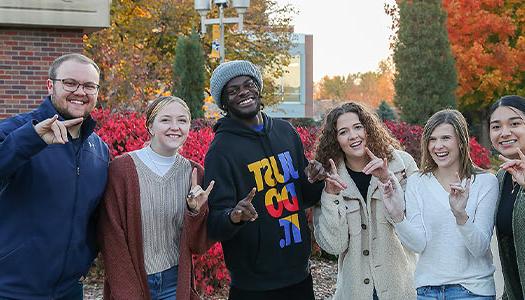 students pose for a photo outdoors